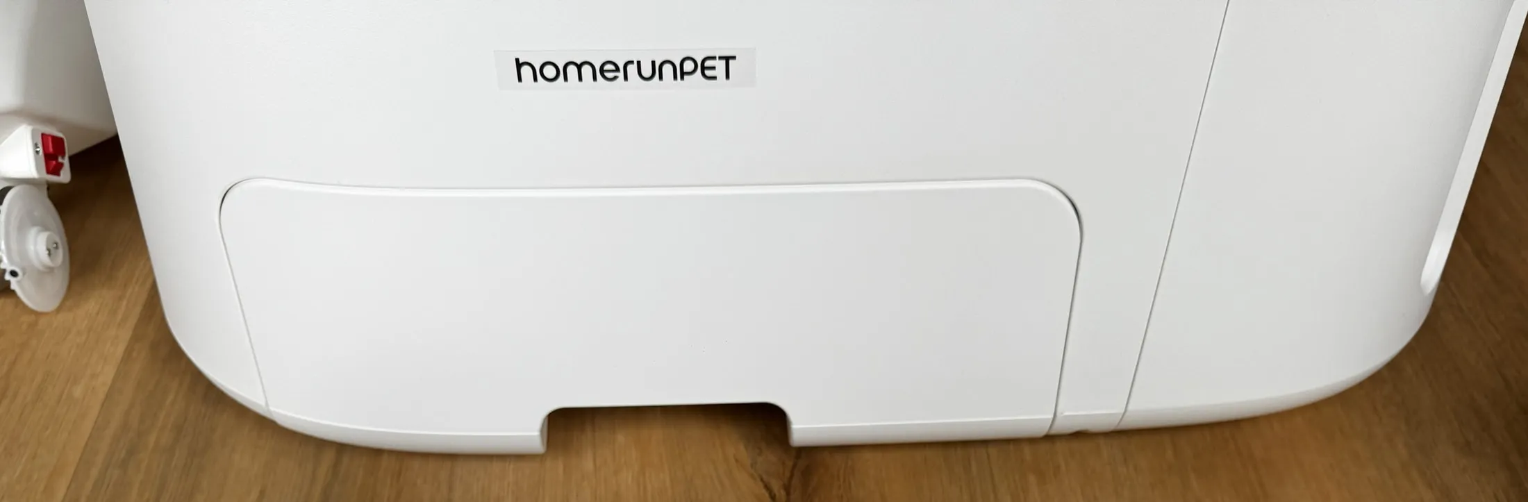 Front waste drawer area of the homerunPET CS106, showing the sealed lower drawer used for waste-bag changes